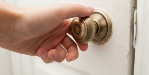 Hand opening the door